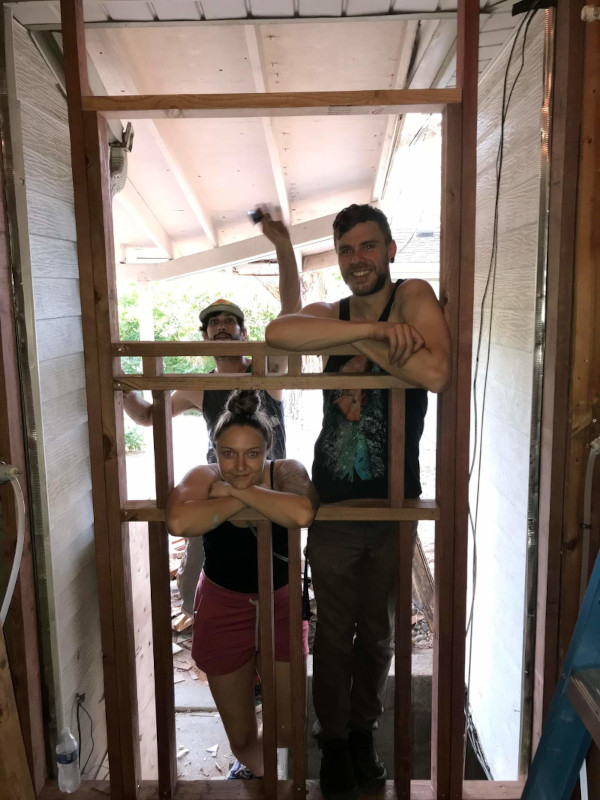 My partner, my friend, and me after constructing a new wall frame.